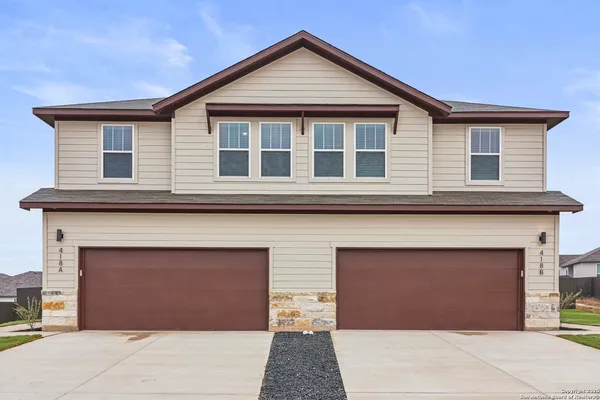 a front view of a house with a garage