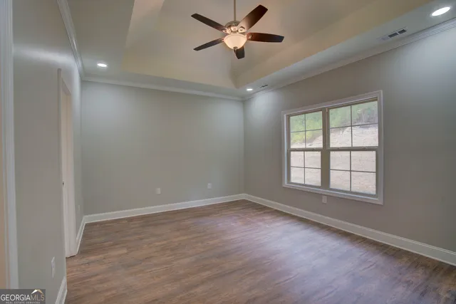 wooden floor in an empty room with a window