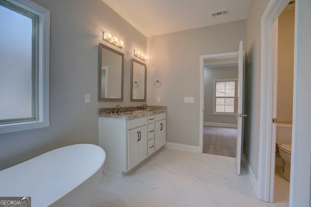 a bathroom with a double vanity sink and a mirror