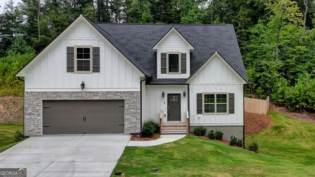 a front view of a house with a yard and garage