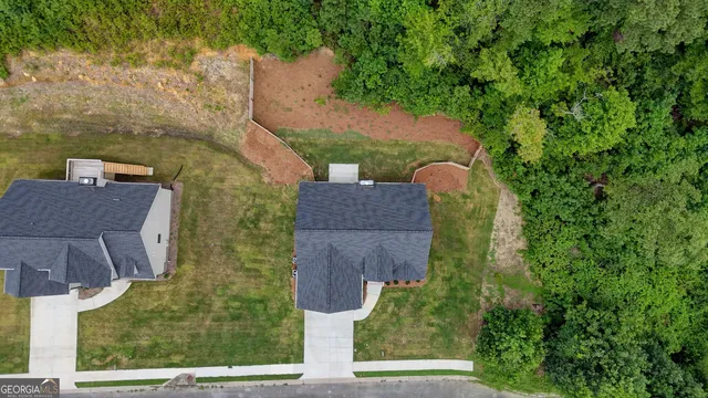 an aerial view of a house with a yard basket ball court and outdoor seating