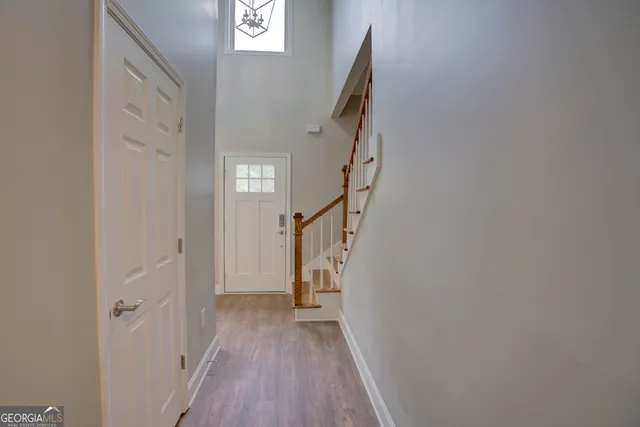 a view of a hallway with wooden floor and entryway