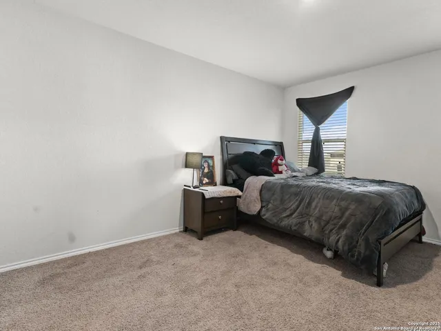 a bedroom with a bed and a night stand