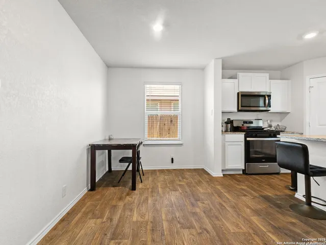 a kitchen with a refrigerator and a stove top oven