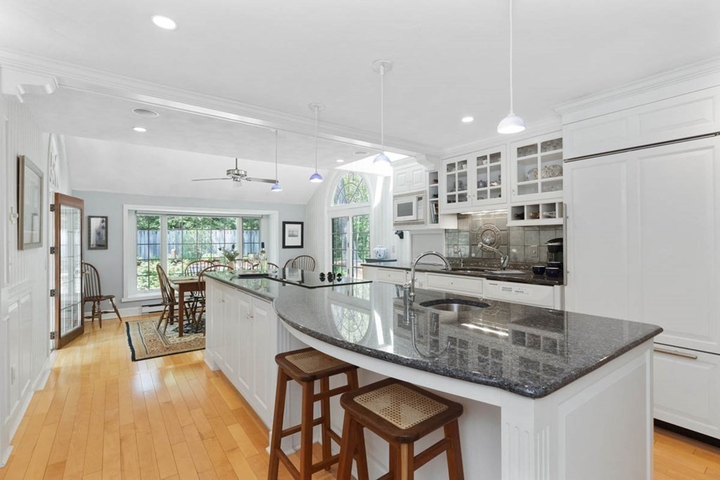 28 Gunnison Road Boxford, MA 01921 - Photo 13 of 37 a kitchen with center island table and chairs