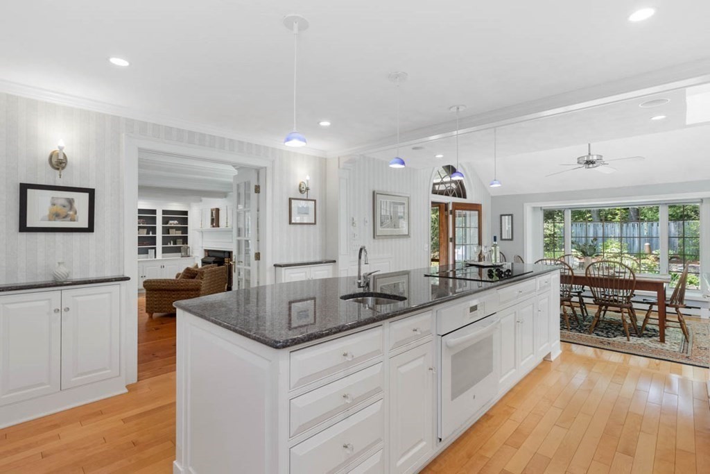 28 Gunnison Road Boxford, MA 01921 - Photo 14 of 37 a large white kitchen with stainless steel appliances granite countertop a lot of counter space and wooden floors