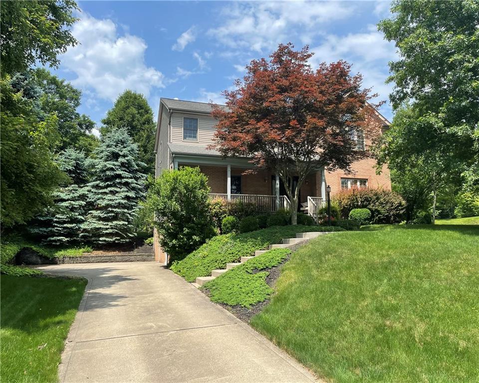 a front view of house with yard and green space