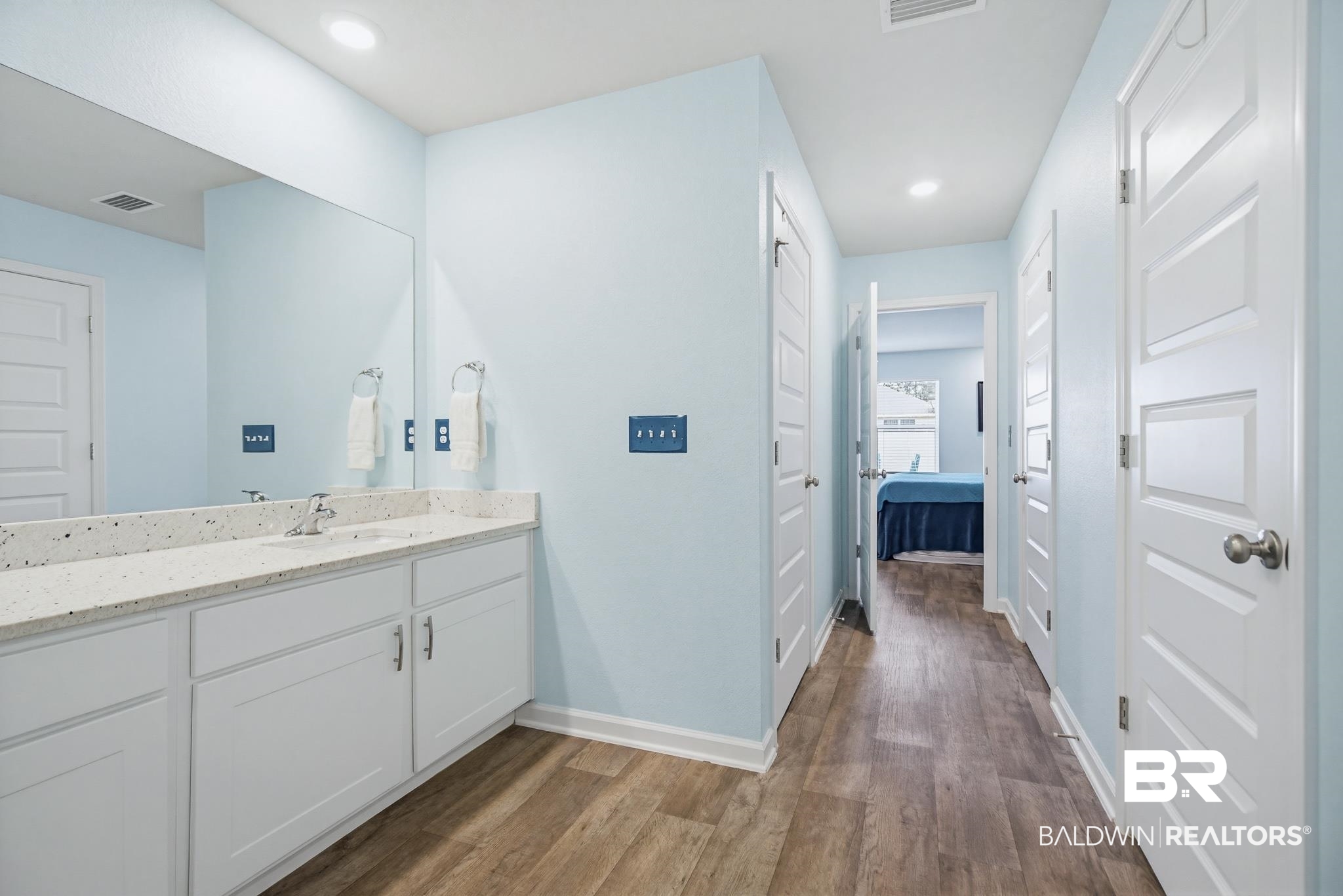 261 Fulham Lane Foley, AL 36535 - Photo 39 of 50 Bathroom with vanity, ensuite bathroom, dark wood finished floors, and recessed lighting