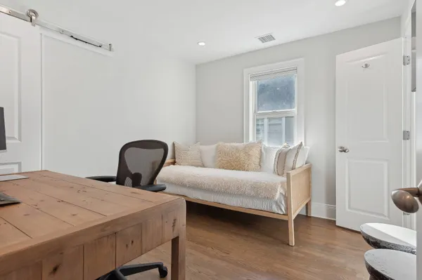 a bedroom with a bed and a couch