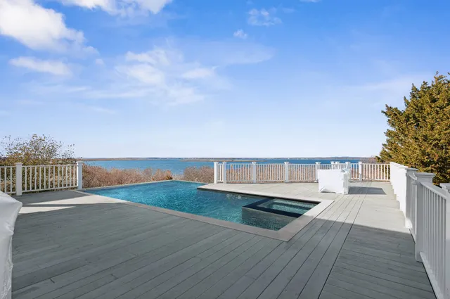 a view of a balcony with wooden floor and fence