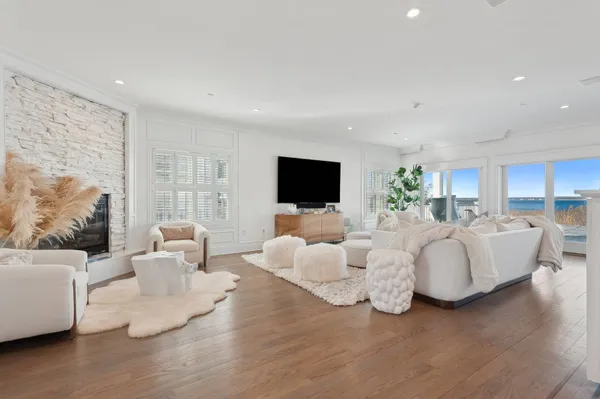 a living room with furniture flat screen tv and white floor