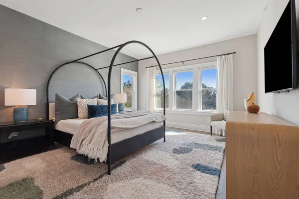 a bedroom with a bed and a flat screen tv