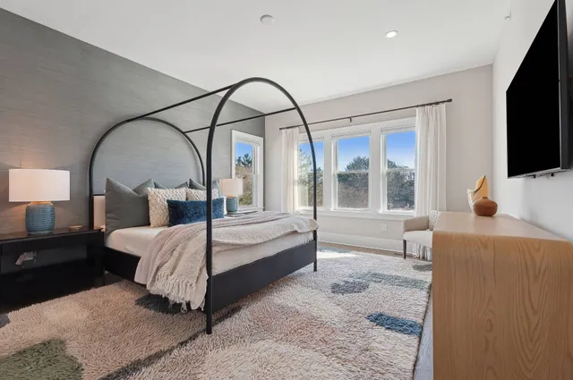 a bedroom with a bed and a flat screen tv