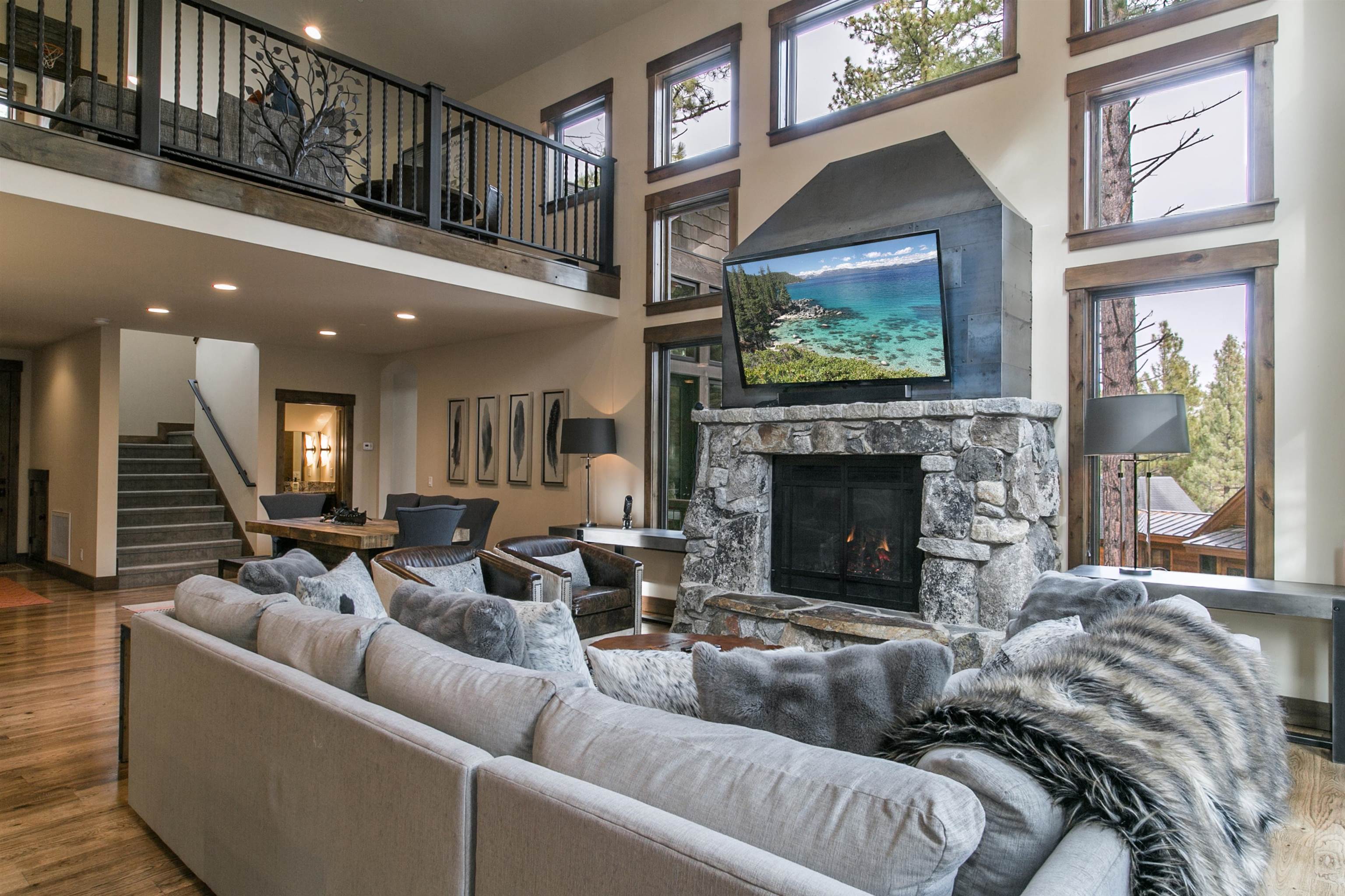 a living room with furniture a flat screen tv and a fireplace