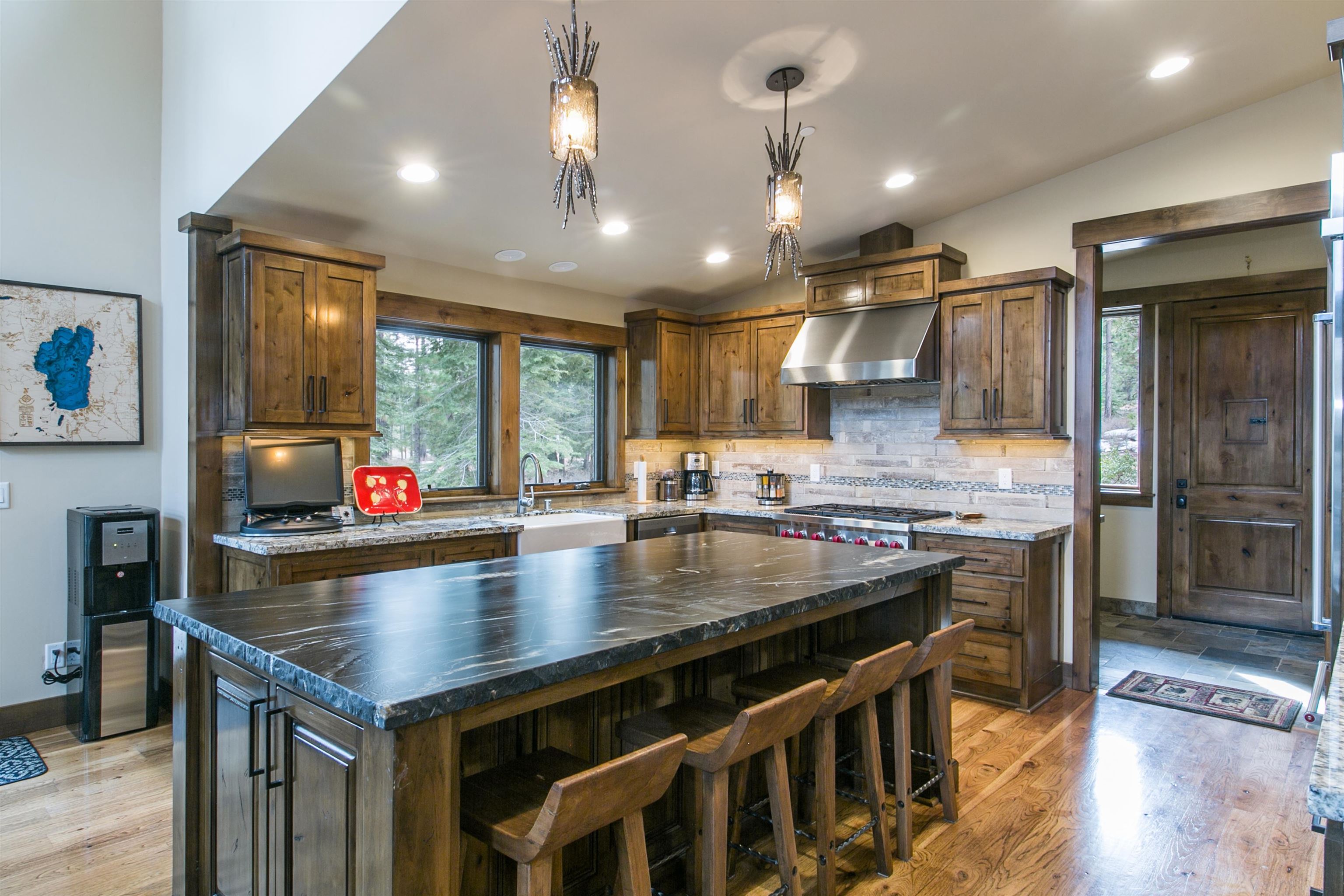 10605 Carson Range Road Truckee, CA 96161 - Photo 19 of 20 a kitchen with kitchen island a large counter top space a sink stainless steel appliances and cabinets