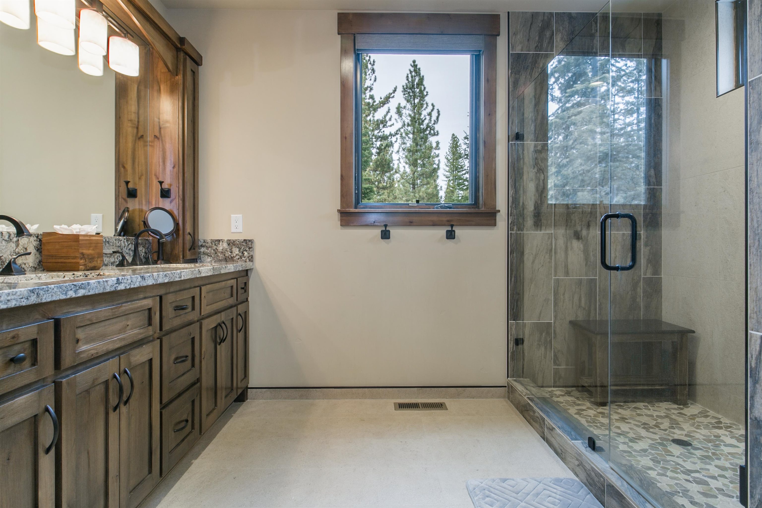 10605 Carson Range Road Truckee, CA 96161 - Photo 9 of 20 a bathroom with a granite countertop sink a mirror and shower