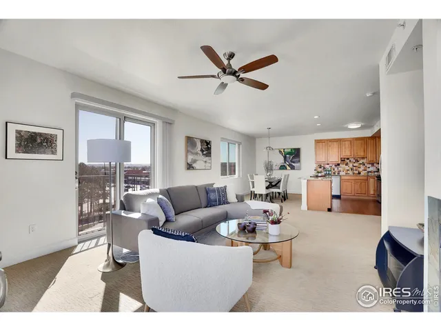 a living room with stainless steel appliances kitchen island granite countertop furniture and a window