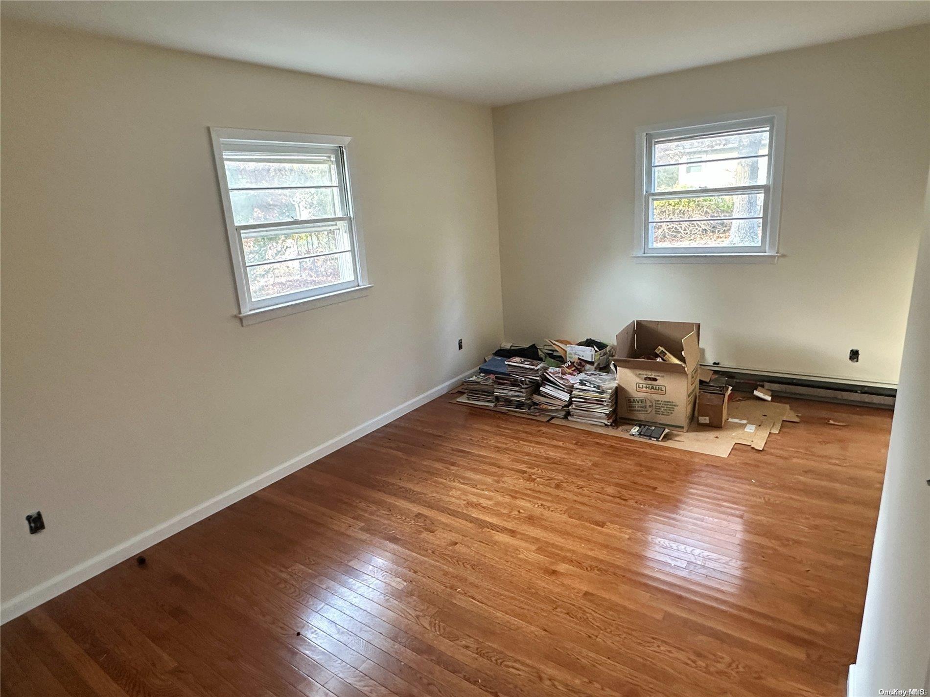 68 Tarpon Road Rocky Point, NY 11778 - Photo 11 of 23 a room with wooden floor and gym equipment