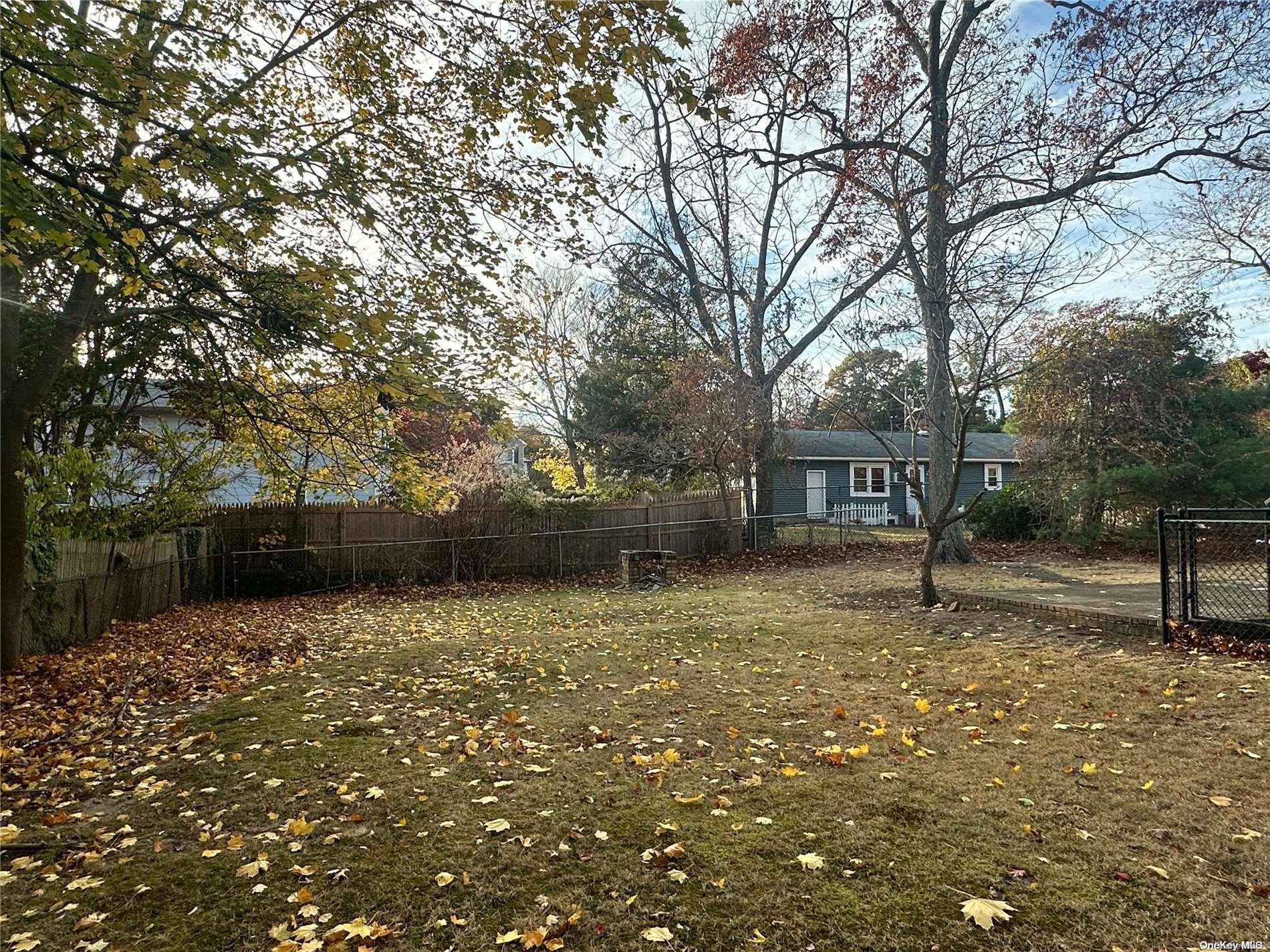 68 Tarpon Road Rocky Point, NY 11778 - Photo 13 of 23 a backyard of a house with lots of green space