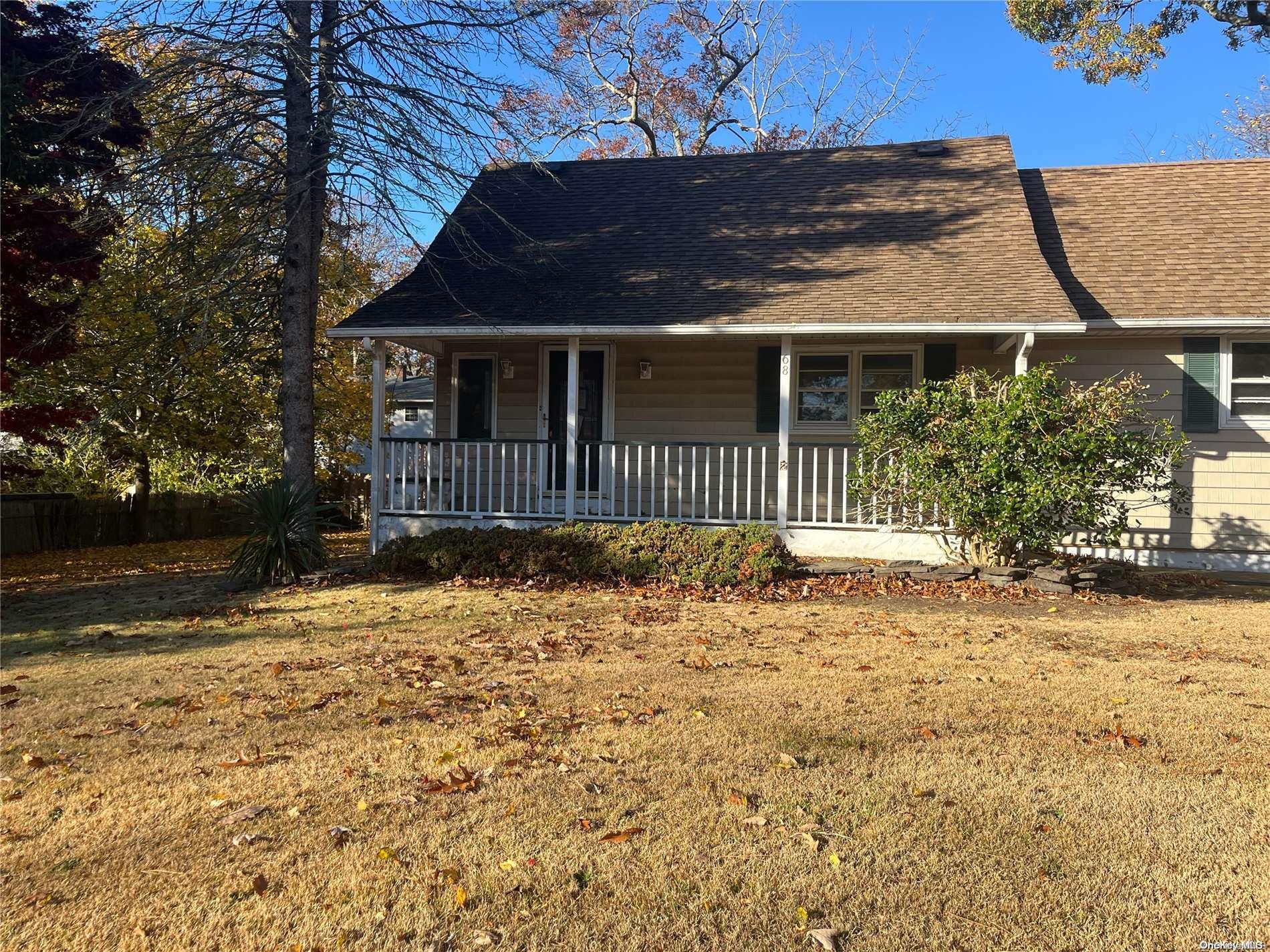 68 Tarpon Road Rocky Point, NY 11778 - Photo 4 of 23 a front view of a house with a garden