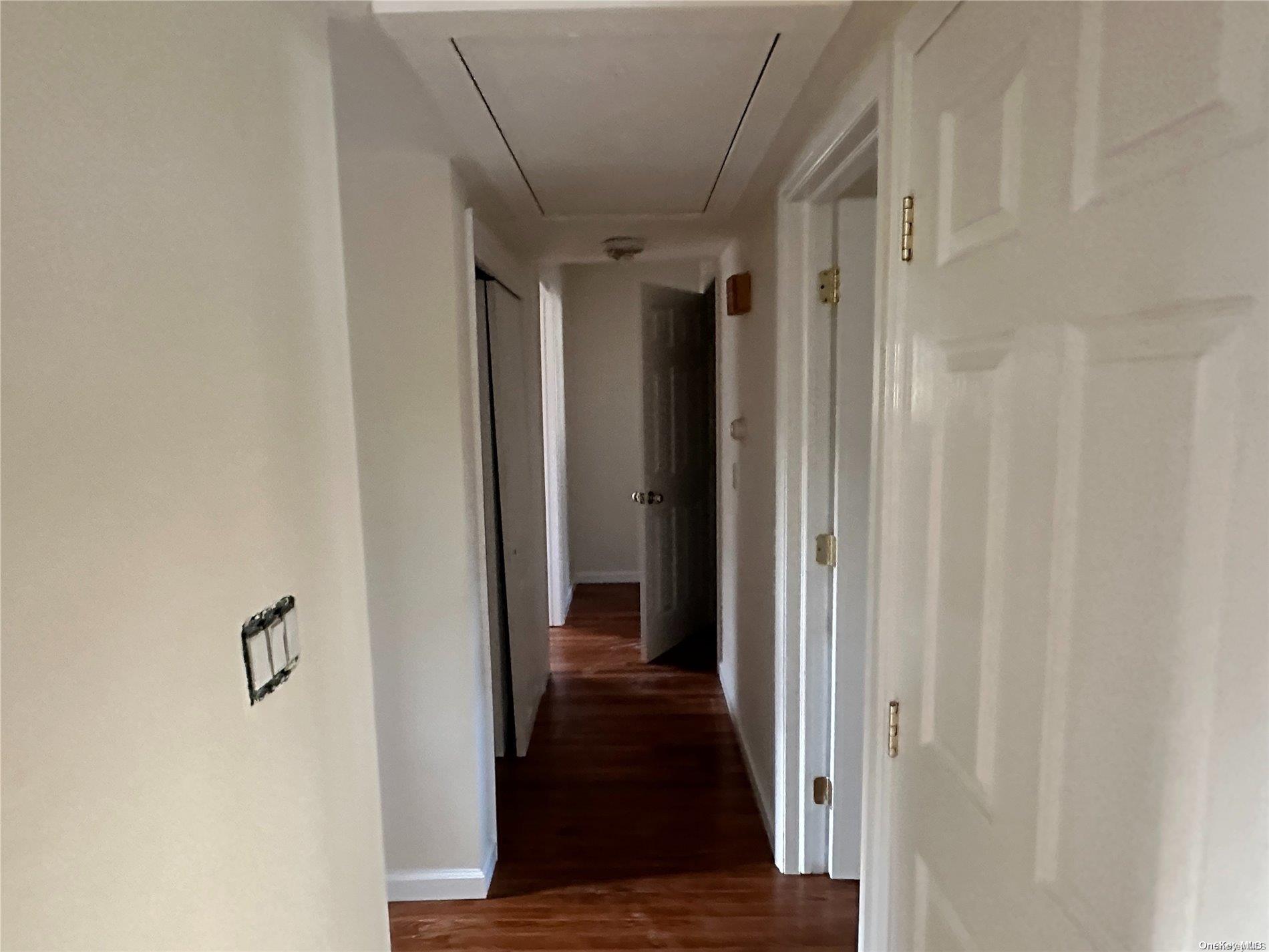 68 Tarpon Road Rocky Point, NY 11778 - Photo 8 of 23 a view of a hallway with wooden floor and staircase