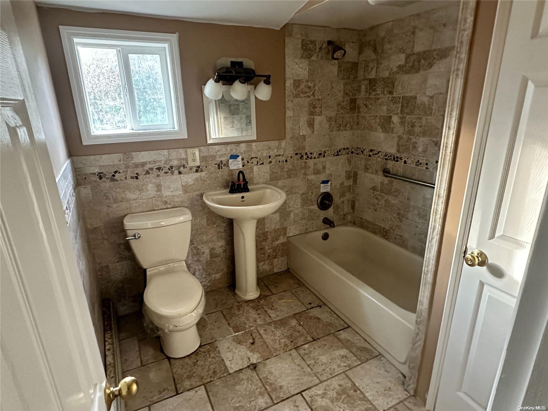 68 Tarpon Road Rocky Point, NY 11778 - Photo 10 of 23 a bathroom with a sink toilet and shower