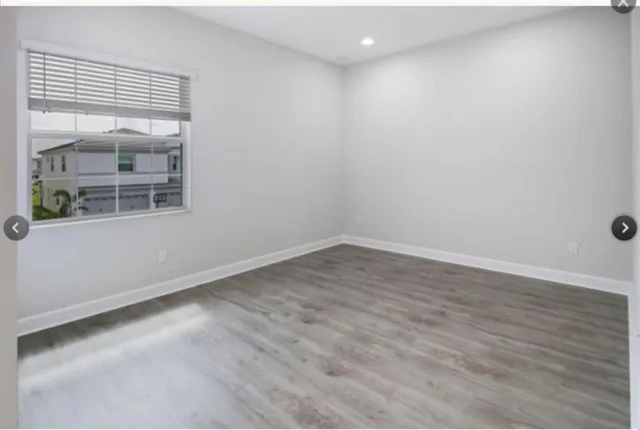 a kitchen with a sink a refrigerator a microwave and cabinets