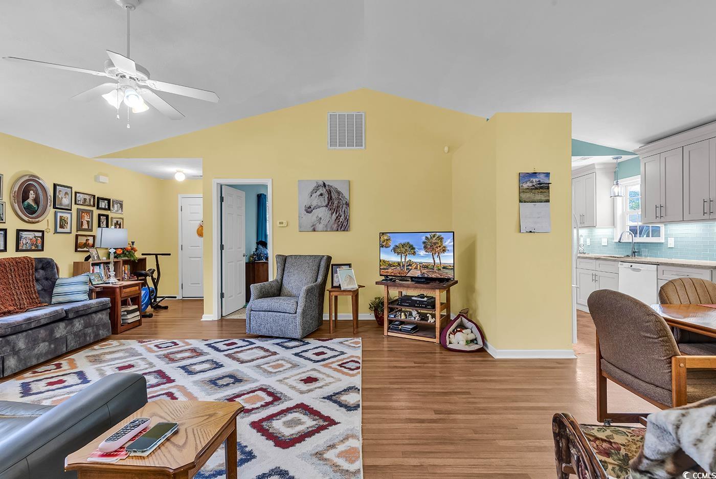 454 Sean River Road Conway, SC 29526 - Photo 11 of 38 Living area featuring lofted ceiling, light wood-style flooring, ceiling fan, and baseboards