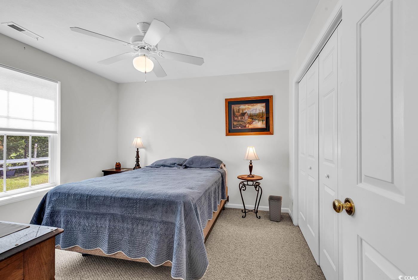454 Sean River Road Conway, SC 29526 - Photo 29 of 38 Bedroom with a closet, light carpet, baseboards, and a ceiling fan