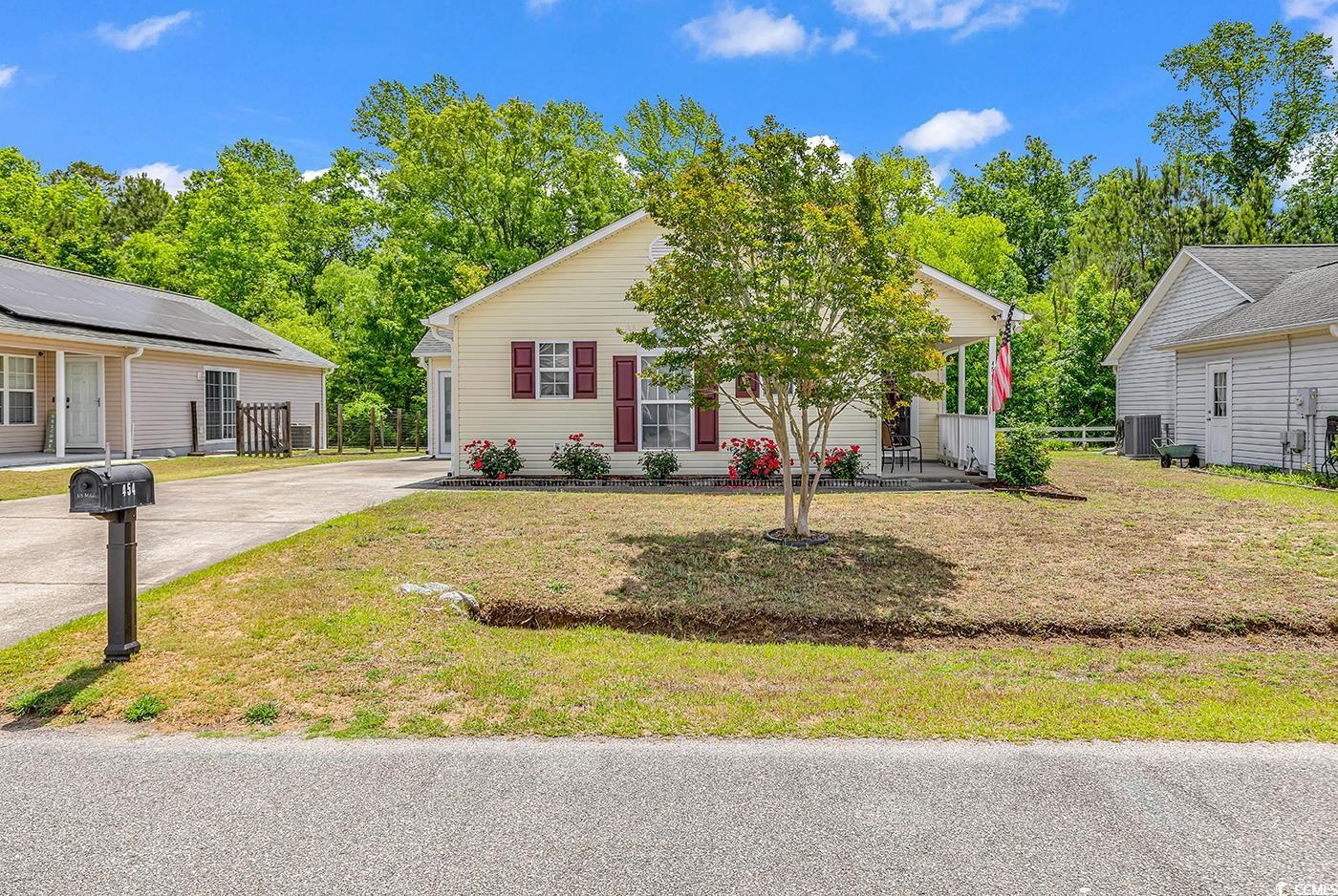 454 Sean River Road Conway, SC 29526 - Photo 33 of 38 View of front facade with a porch, a front yard, central AC, and driveway