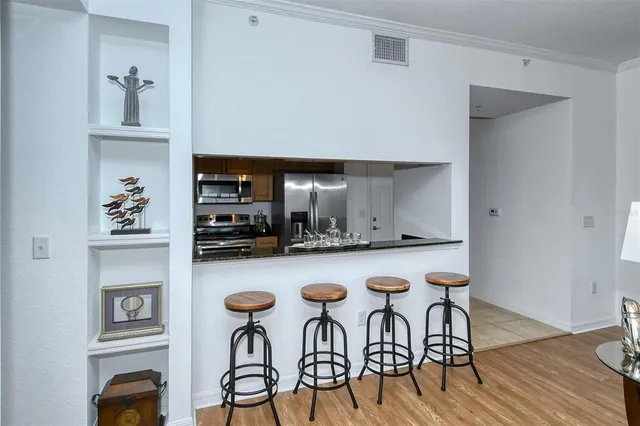 a kitchen with granite countertop a sink and cabinets