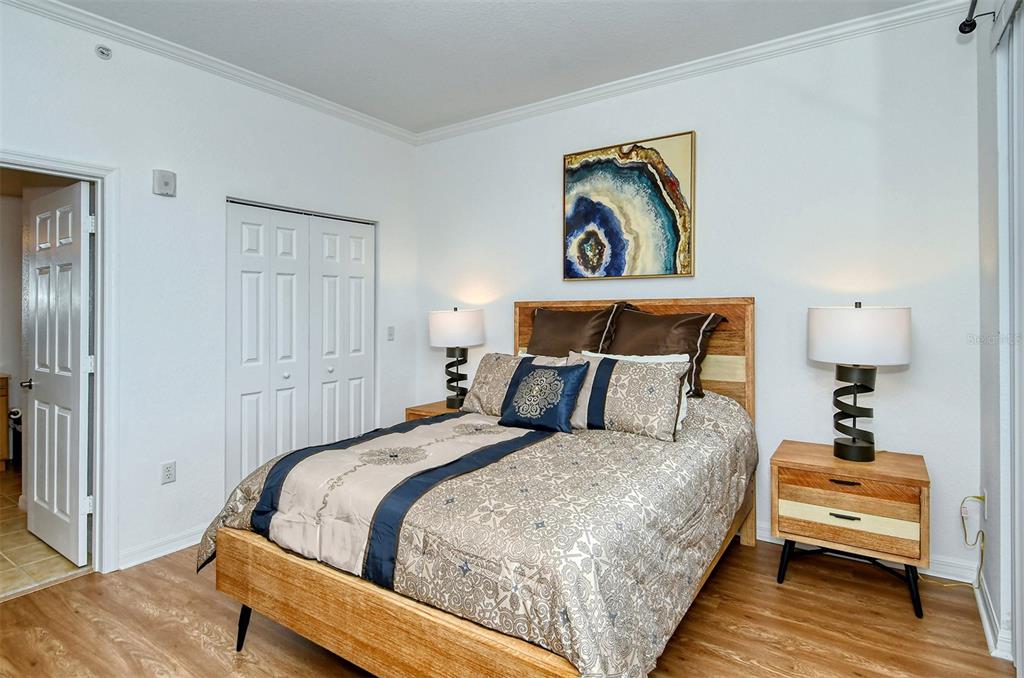 1064 North Tamiami Trail, Unit 1627 Sarasota, FL 34236 - Photo 16 of 97 a bedroom with a bed and a painting on the wall