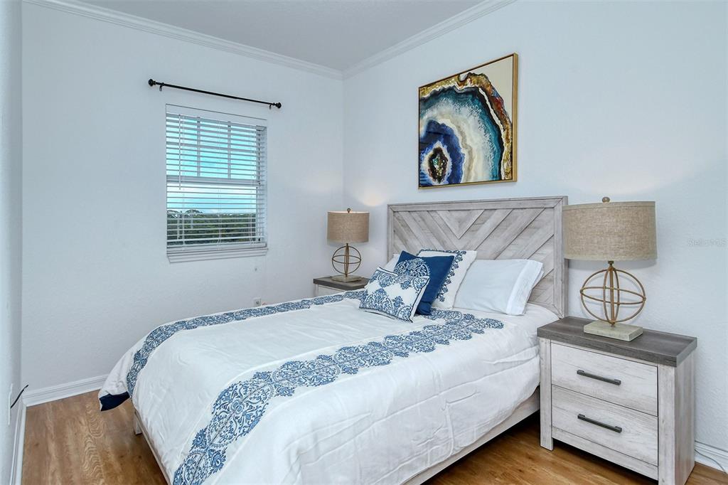 1064 North Tamiami Trail, Unit 1627 Sarasota, FL 34236 - Photo 25 of 97 a bedroom with a bed and a painting on the wall
