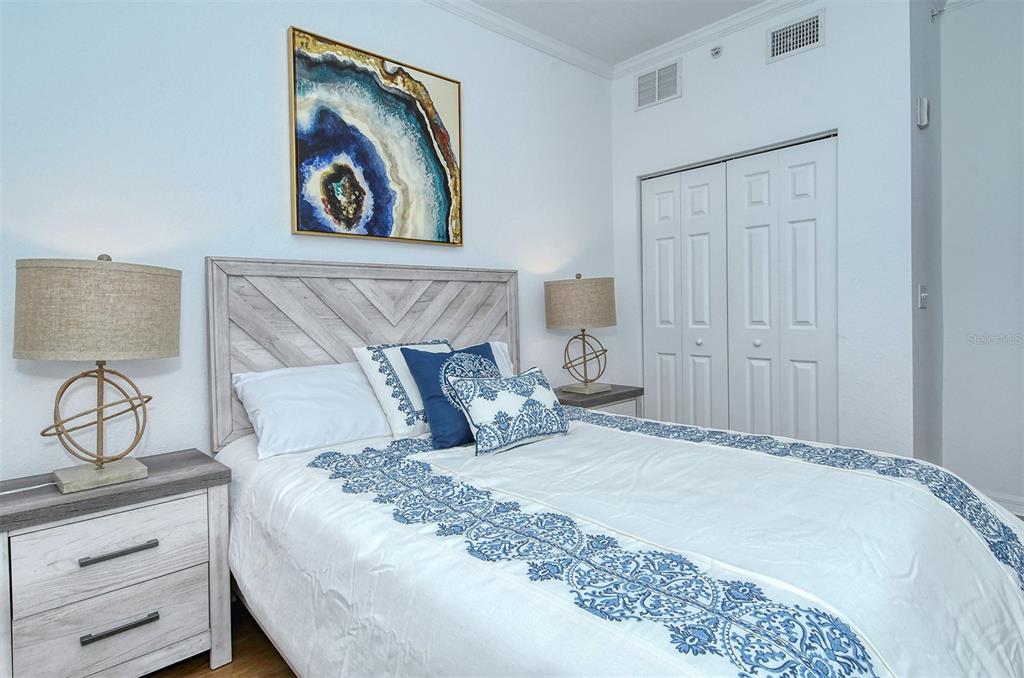 1064 North Tamiami Trail, Unit 1627 Sarasota, FL 34236 - Photo 26 of 97 a bedroom with a bed and painting on the wall