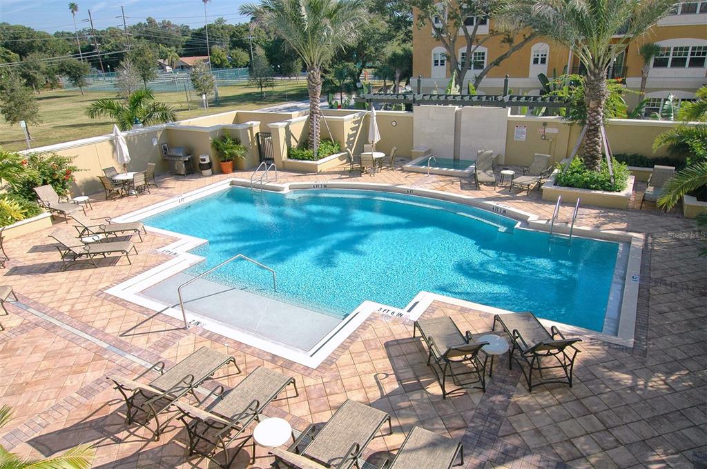 1064 North Tamiami Trail, Unit 1627 Sarasota, FL 34236 - Photo 37 of 97 a view of swimming pool with outdoor seating and plants