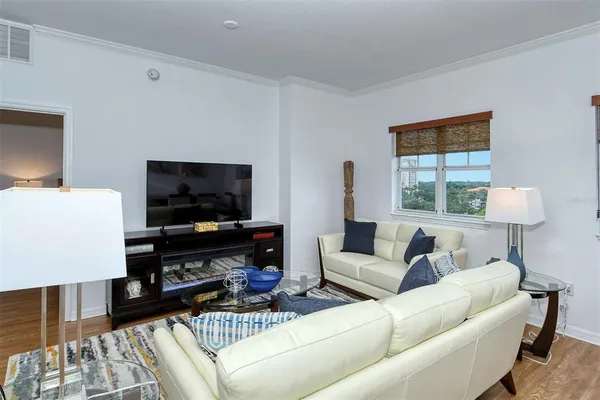 a living room with furniture a lamp and a flat screen tv