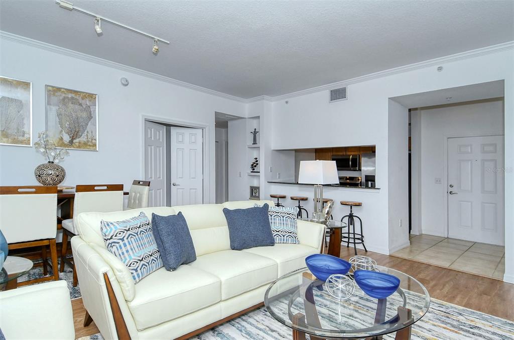 1064 North Tamiami Trail, Unit 1627 Sarasota, FL 34236 - Photo 7 of 97 a living room with furniture and a wooden floor