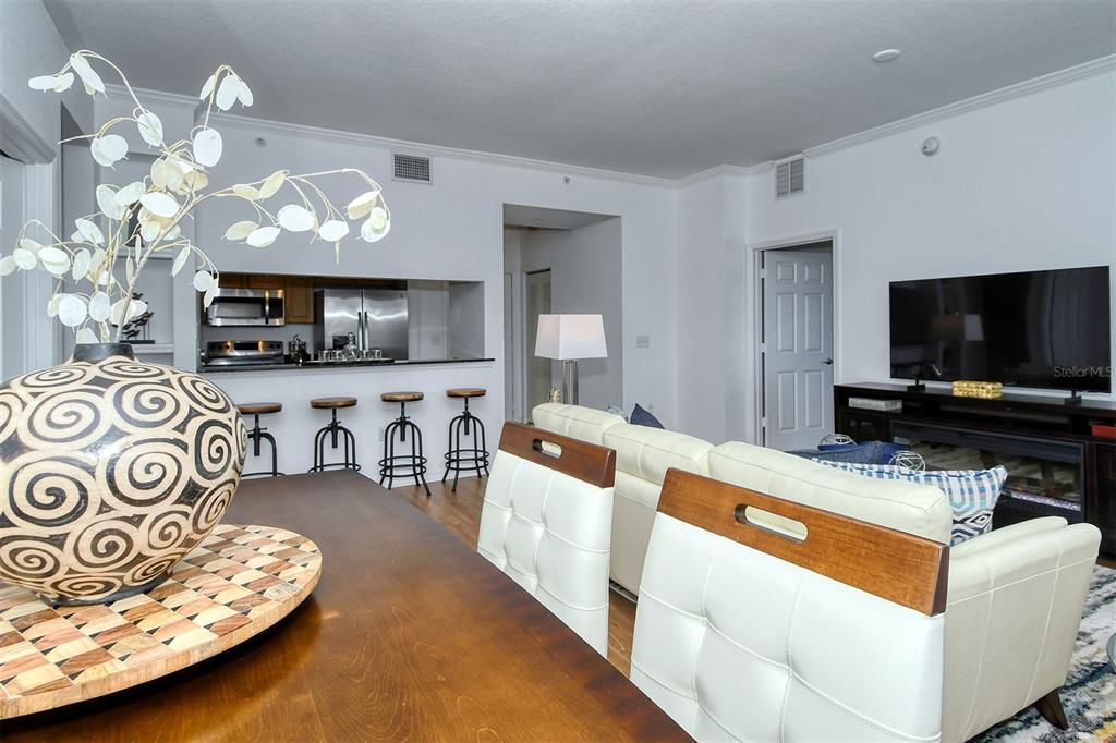 1064 North Tamiami Trail, Unit 1627 Sarasota, FL 34236 - Photo 10 of 97 a living room with furniture and a flat screen tv