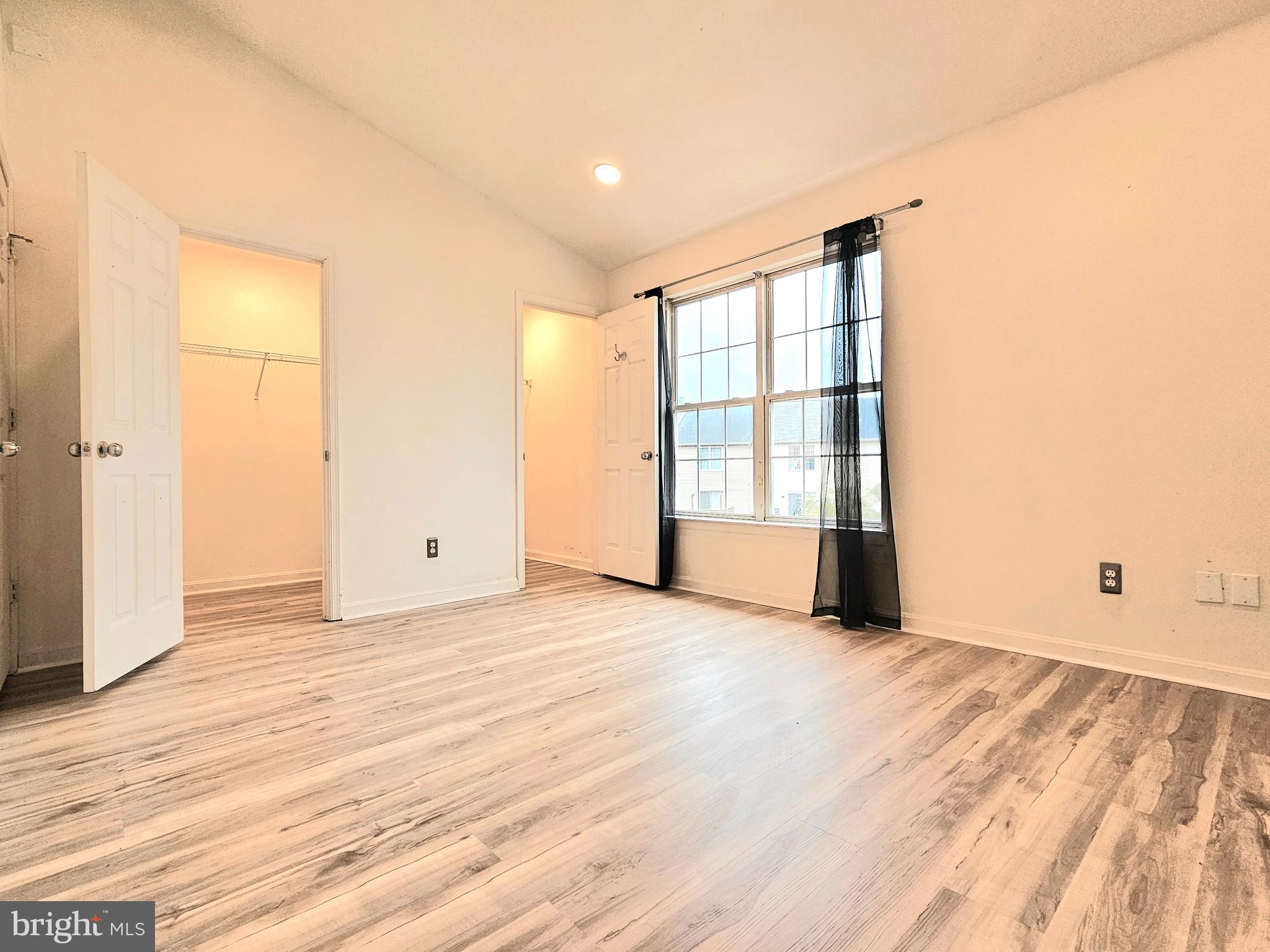 605 Villager Circle Baltimore, MD 21222 - Photo 14 of 41 a view of an empty room with wooden floor and a window