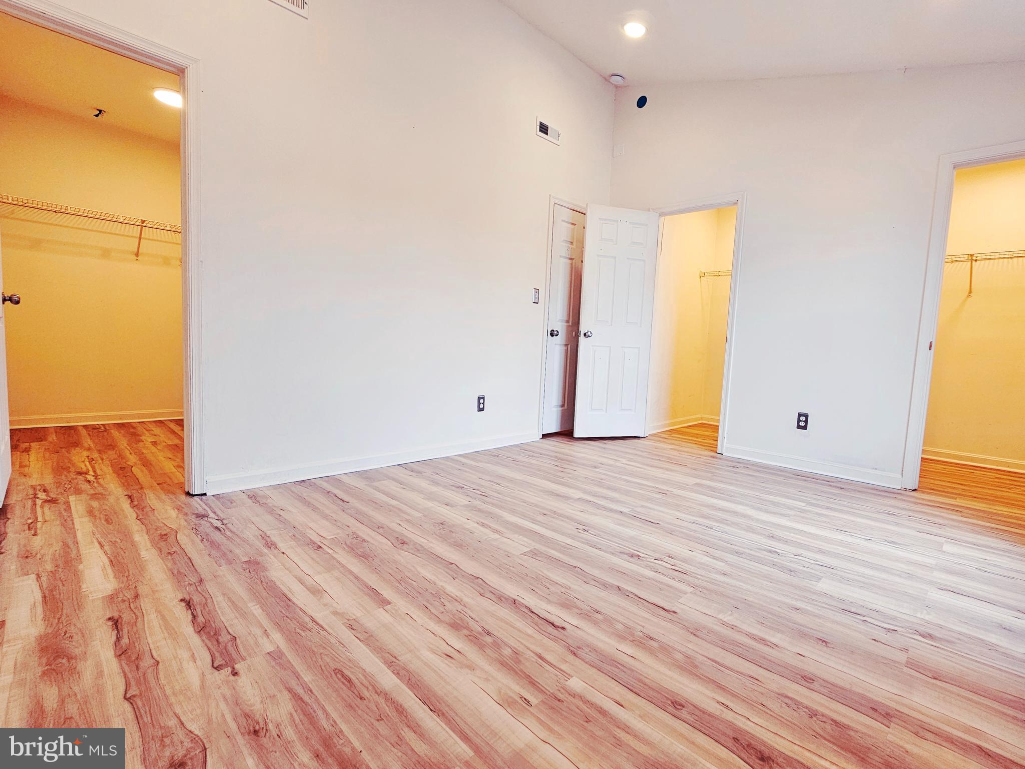 605 Villager Circle Baltimore, MD 21222 - Photo 15 of 41 a view of empty room with wooden floor and fan