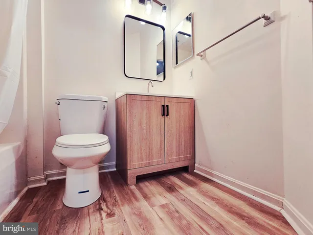 a bathroom with a toilet and a mirror