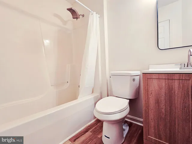 a bathroom with a toilet a sink and bathtub