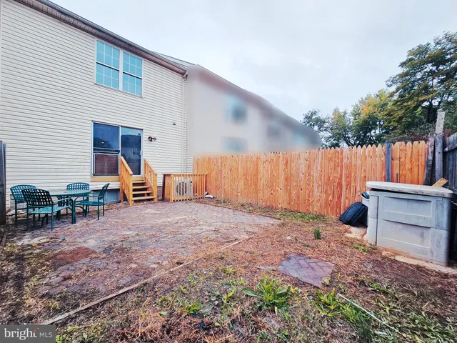 a backyard of a house with barbeque oven and outdoor seating