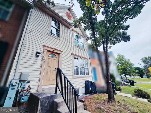 a view of a house with a tree in the background