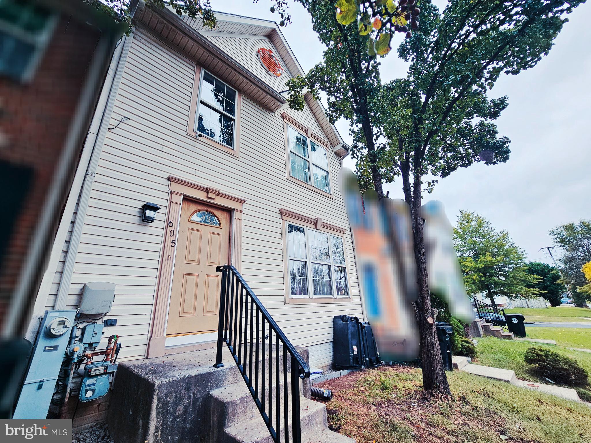 605 Villager Circle Baltimore, MD 21222 - Photo 4 of 41 a view of a house with a tree in the background