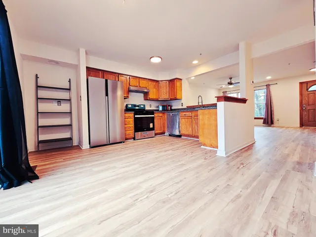 a view of a kitchen with a sink and a refrigerator