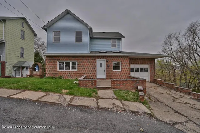 a front view of a house with a yard and a garage