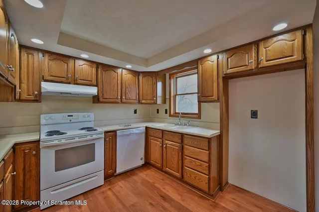 a kitchen with a stove a sink and a refrigerator