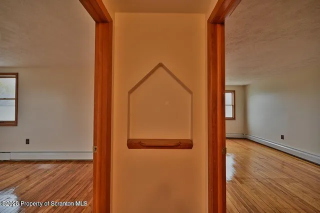 a view of walk in closet with wooden floor
