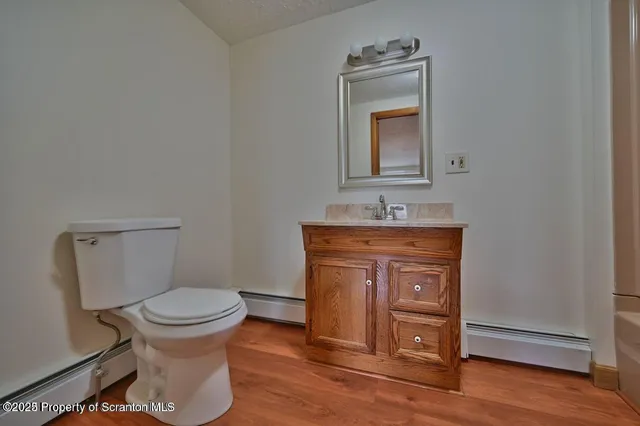 a bathroom with a tub sink and mirror